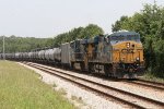 CSX 5438 and 5382 pause with a line of tank cars